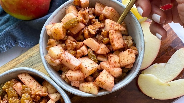 Spiced baked apple chunks and walnuts in bowl