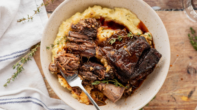 Plate of red wine-braised beef short ribs on bed of mashed potatoes