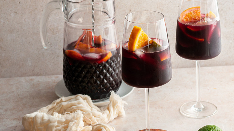 Fruity red wine sangria served from pitcher into glasses