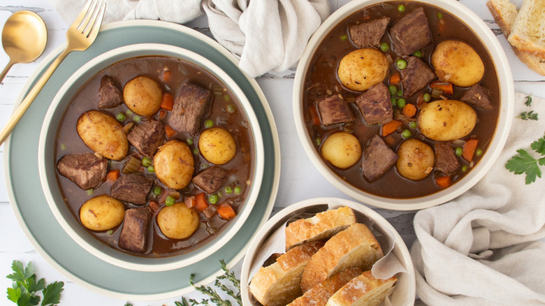 Two bowls of beef, potato, and vegetable stew