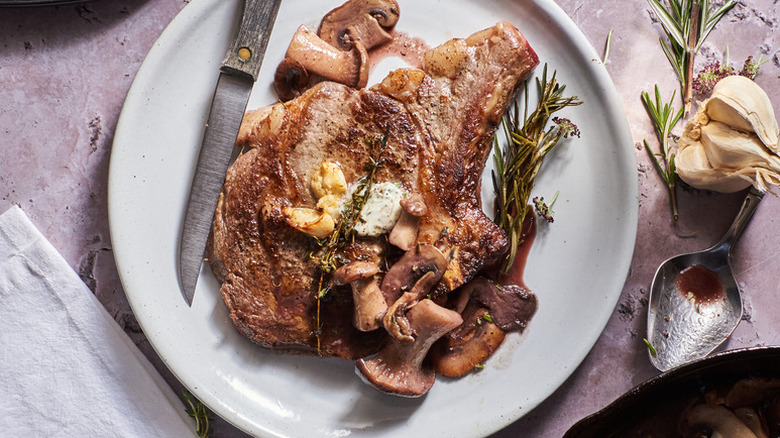 Plate of steak with red wine mushrooms and rosemary