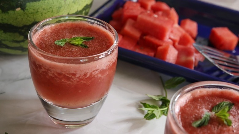 Frozen watermelon ginger margaritas in glasses, garnished with fresh mint
