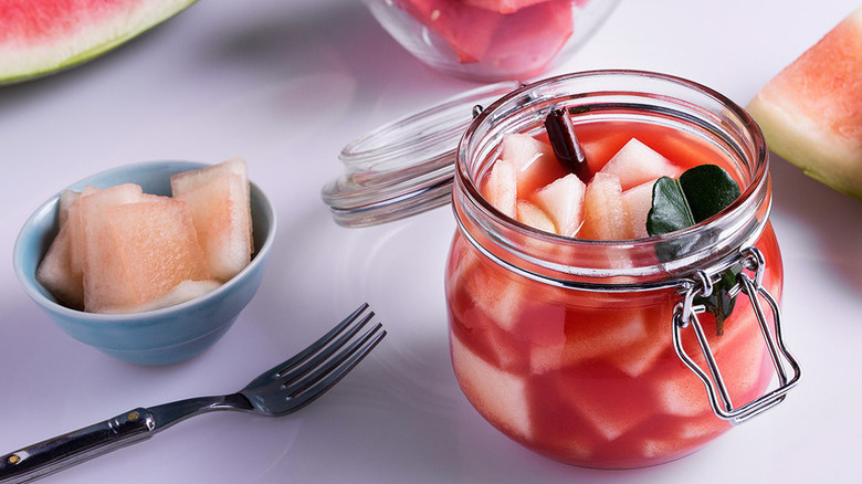 Pickled watermelon rind in open glass jar