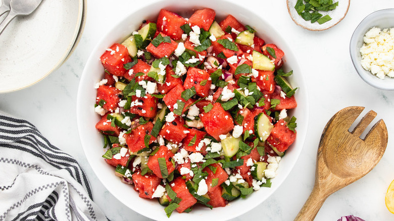 Watermelon, feta, mint, and cucumber salad in white bowl