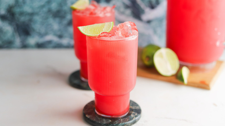 Watermelon lime agua fresca in glasses with ice and lime wedges
