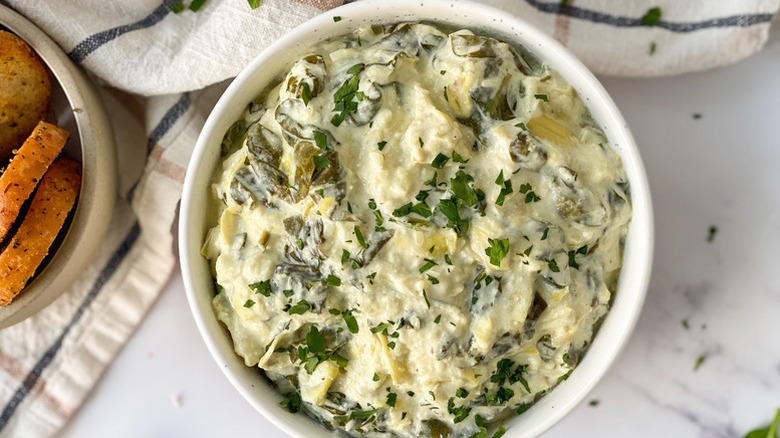Spinach artichoke dip in white bowl