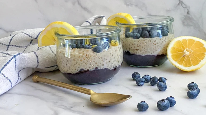 Blueberry-Lemon Tapioca Pudding in small glass jars with lemon and blueberries