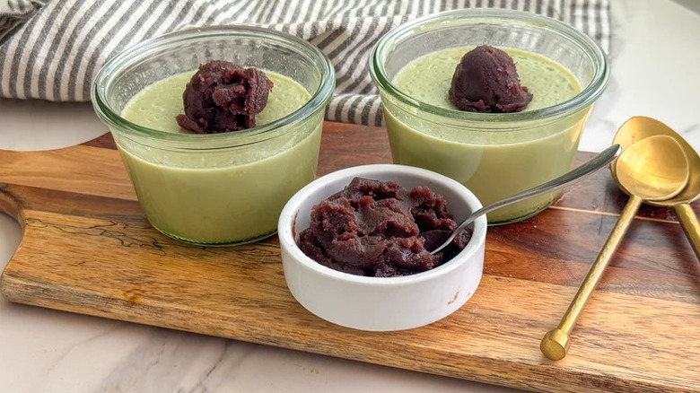 Matcha Pudding with Sweet Red Bean Paste on wooden board with gold spoons