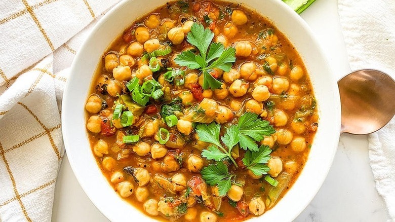 Bowl of chana masala chickpea curry, topped with fresh cilantro