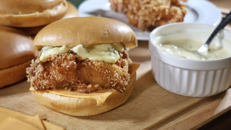 Copycat McDonald's Filet-O-Fish with tartar sauce on wooden cutting board