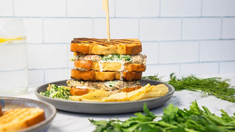 Grilled Salmon Salad Sandwich stacked on grey plate