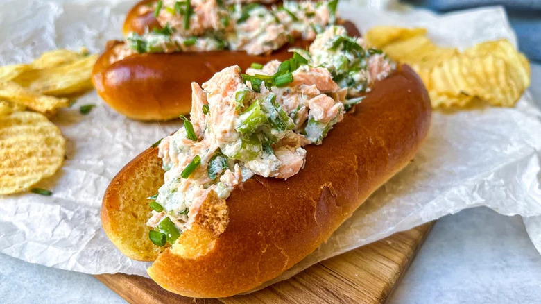 Maine-ish Salmon Salad Rolls with chips on parchment paper