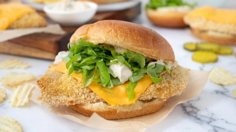 Oven-Fried Fish Sandwich with Triple Pickle Tartar on piece of parchment paper