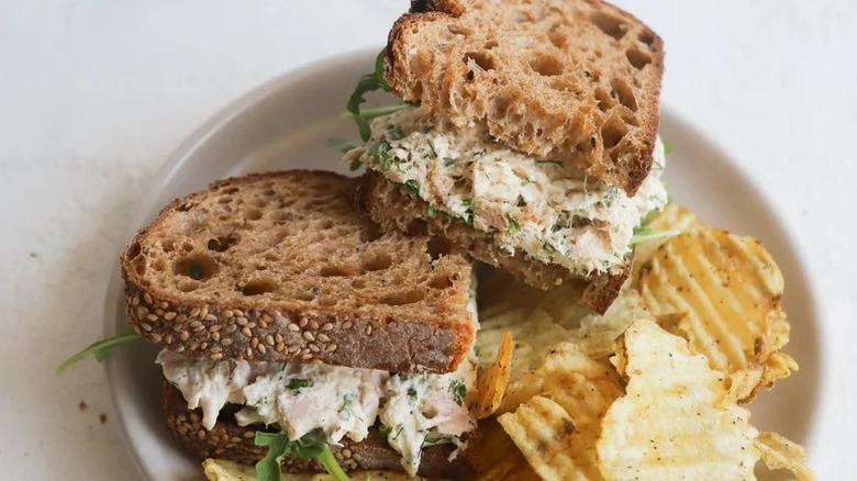 Simple Yet Refined Tuna Sandwich with potato chips on small white plate