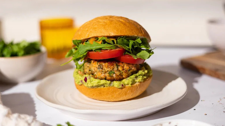 Spicy Salmon Burger with Guacamole on white plate