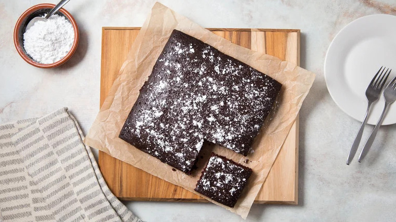 Depression-Era Wacky Cake on parchment paper on wooden cutting board