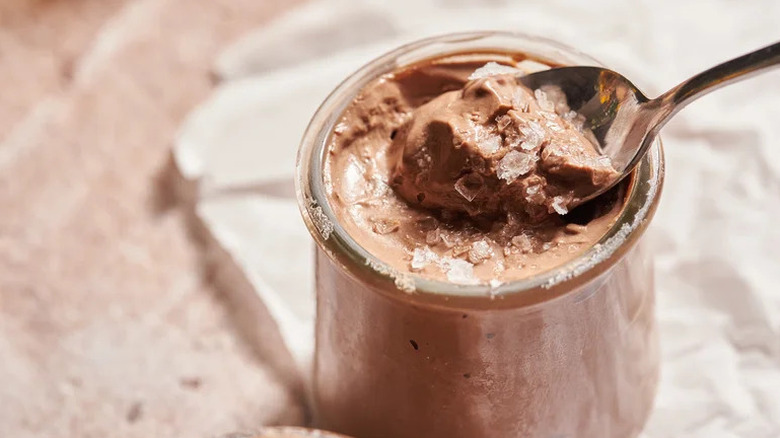 Plant-Based Chocolate Caramel Tofu Mousse in small glass jar with spoon