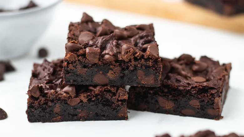 Rich Vegan Brownies stacked on white surface