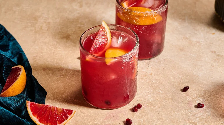 Blood Orange and Pomegranate Margarita Cocktail in tumblers with fruit garnishes