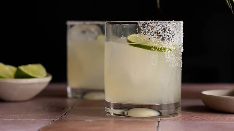 Classic Margarita Cocktail in tumblers with salt rim