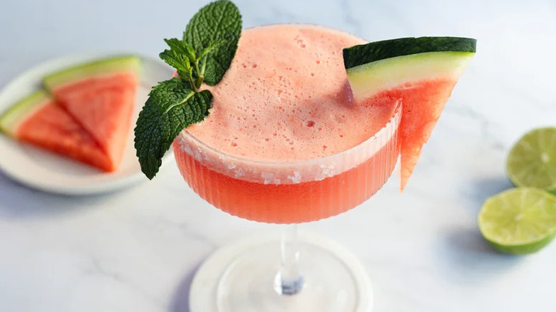 Frozen Watermelon Mezcal Margarita in coupe glass with watermelon and mint garnishes