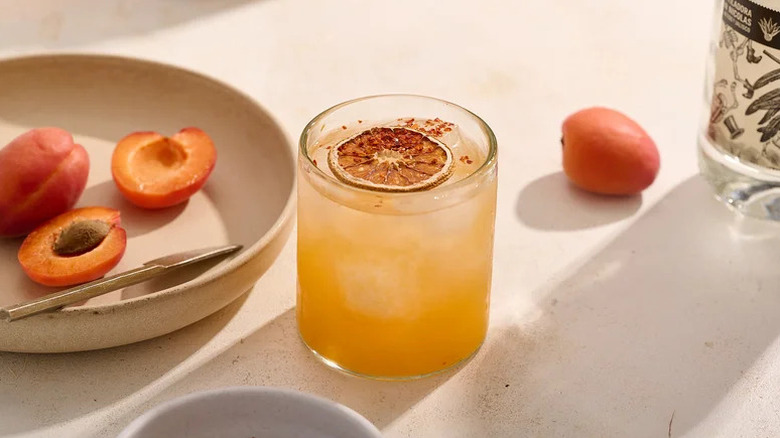 Hot Honey Apricot Margarita next to plate of apricots