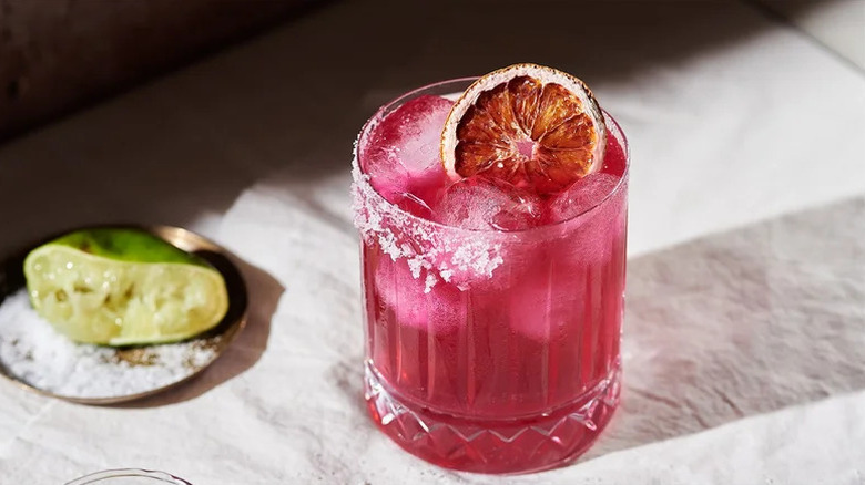 Prickly Pear Cactus Margarita in tumbler with dried orange garnish