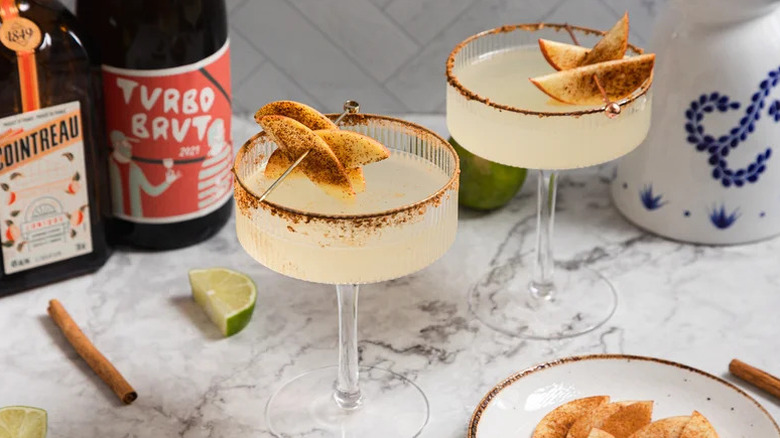 Skinny Apple Cider Margaritas in two coupe glasses with apple garnishes