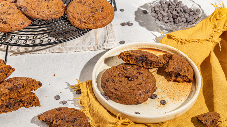 Pumpkin chocolate chip cookies on cooling rack and plate