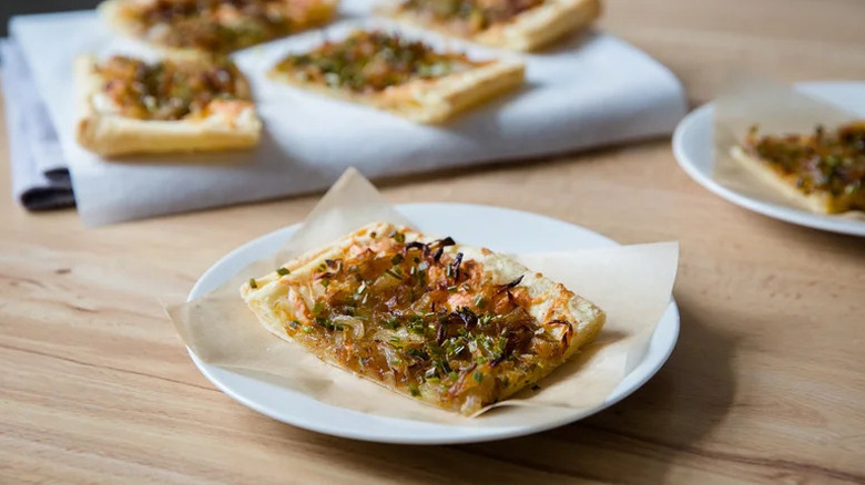 Caramelized Onion Tart on parchment paper on white plate