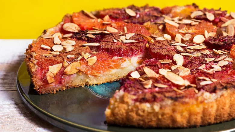 Citrus-Almond Tart on black plate with yellow background