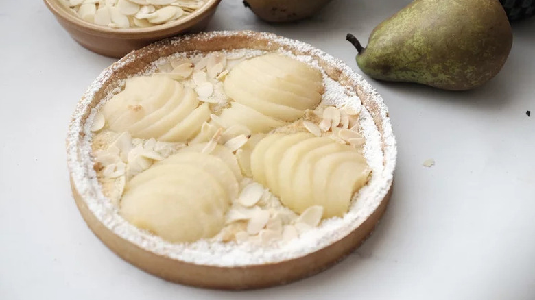 Pear Almond Tart on white table with pear