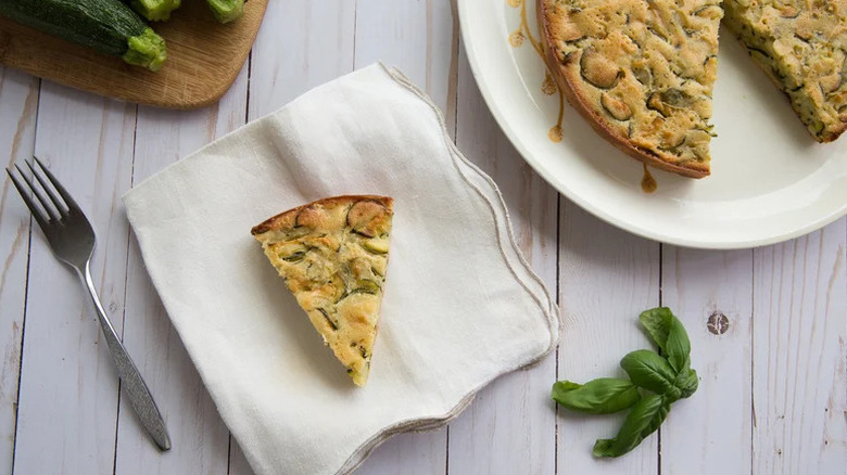 Slice of Scarpaccia Dolce (Sweet Italian Zucchini Tart) on white cloth napkin