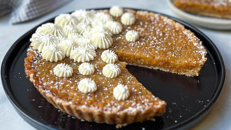 Simple Treacle Tart on black plate