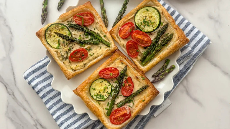 Summer Vegetable Puff Pastry Tarts on white plate with scalloped edges