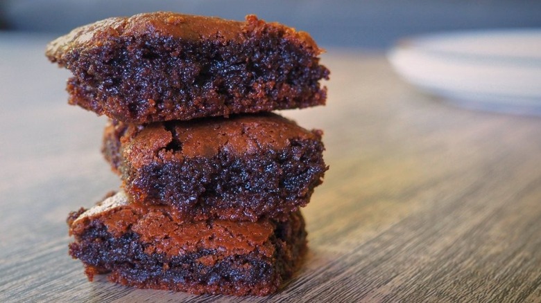 3-Ingredient Nutella Brownies stacked on wooden table