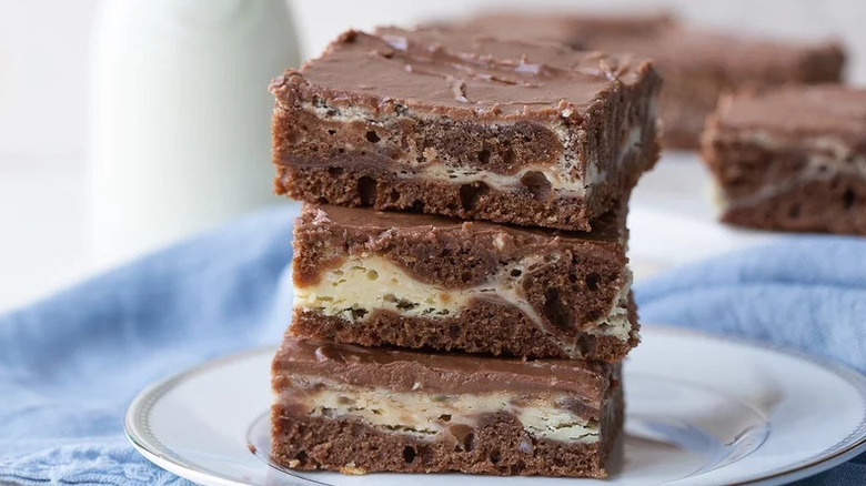 Cream Cheese Brownies stacked on white plate