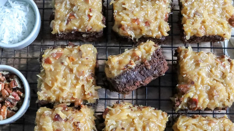 Fudgy German Chocolate Brownie Bars on cooking rack with nuts and coconut