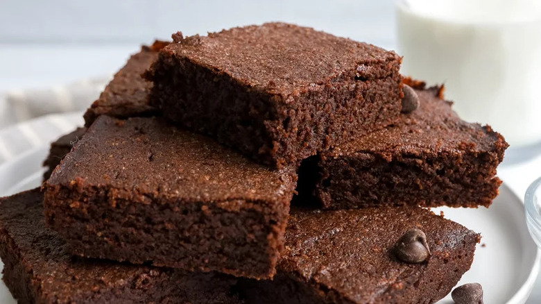 Fudgy Keto Brownies stacked on white plate