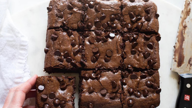 Hand grabbing Papa John's Brownie Copycat