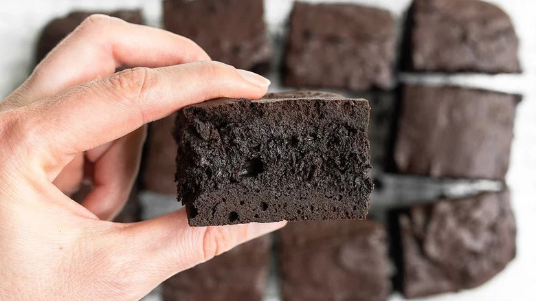 Hand holding an Ultimate Fudgy Brownie