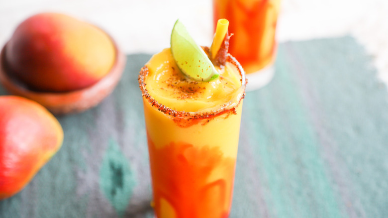 Frozen mangonada with Tajin and lime garnish
