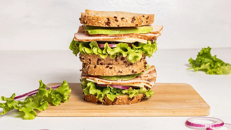 Turkey sandwiches stacked on cutting board