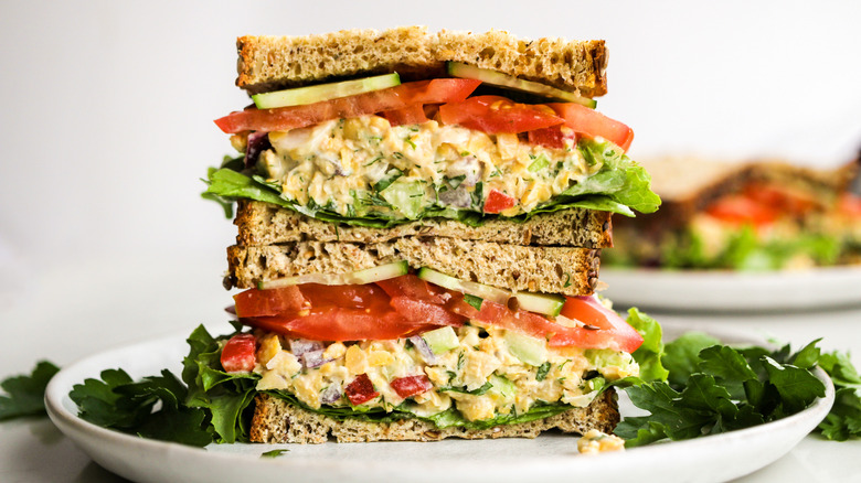 Chickpea salad sandwich stacked on plate