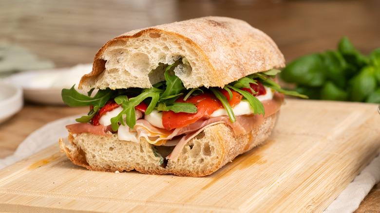 Prosciutto sandwich on wooden board