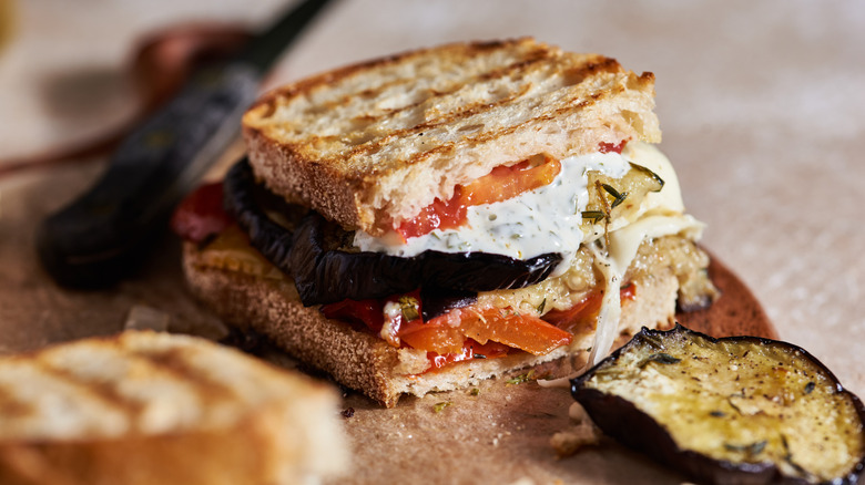 Eggplant panini next to slice of eggplant