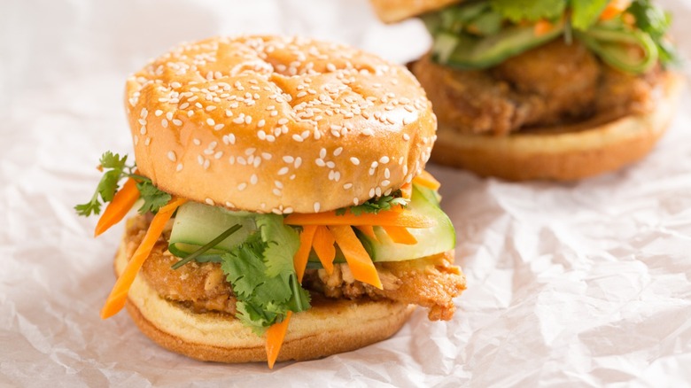 Peanut-crusted chicken sandwich with carrot and herb toppings