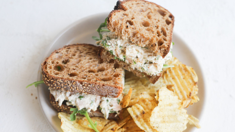 Tuna salad sandwich and chips on plate