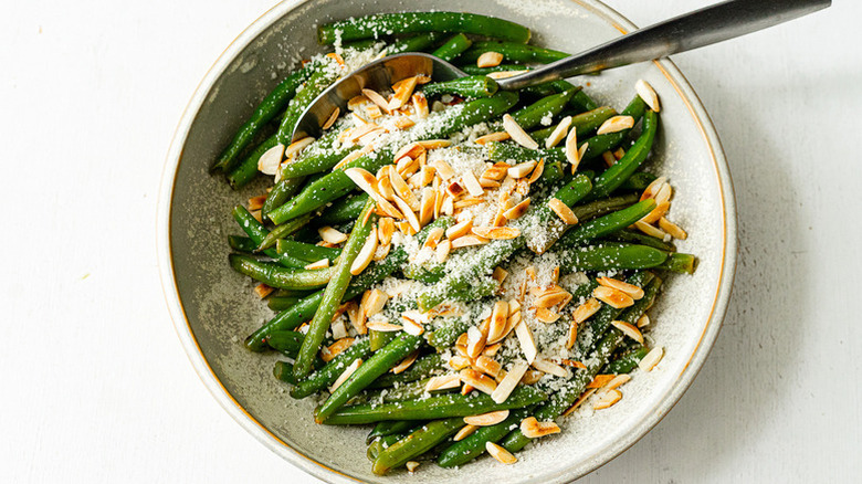 Green bean almondine in bowl with spoon