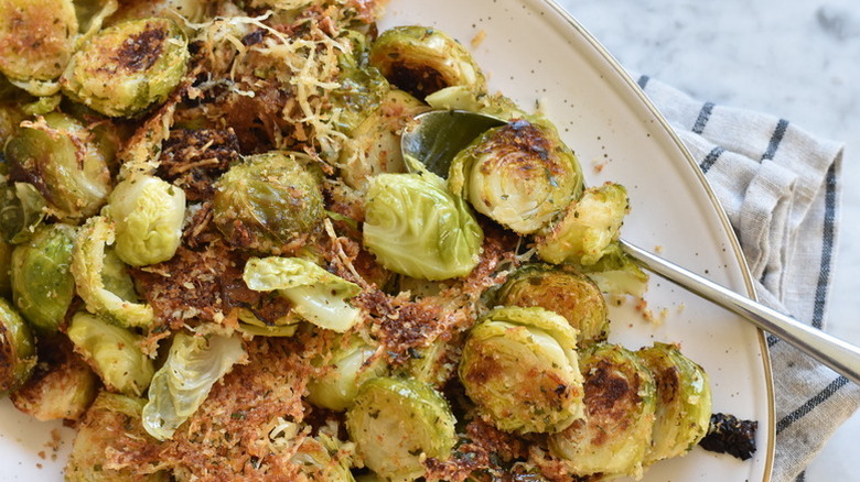 Parmesan-crusted Brussels sprouts on plate with spoon